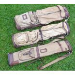 3x various canvas and leather oval golf bags, 2 with travel hoods, all with shoulder straps