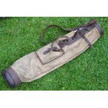 A useful canvas and leather golf bag c/w ball pocket, shoulder strap and travel hood