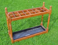 Large oak umbrella stand c/w steel tray divided into 18 sections ideal for displaying gold clubs -