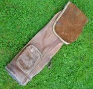 A good leather oval golf bag c/w travel hood and ball pocket, requiring a new shoulder strap and a