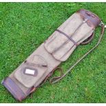 Good size canvas and leather oval golf bag with travel hood and other side pockets and shoulder