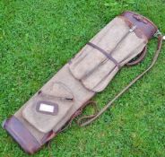 Good size canvas and leather oval golf bag with travel hood and other side pockets and shoulder