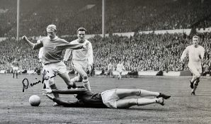 Denis Law Signed Manchester United Football Print a b&w print of Law dribbling the ball, slight