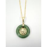 CHINESE CIRCULAR JADE PENDANT with eighteen carat gold Chinese character decoration to the centre,