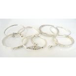 EIGHT SILVER BANGLES of various size and design (8)