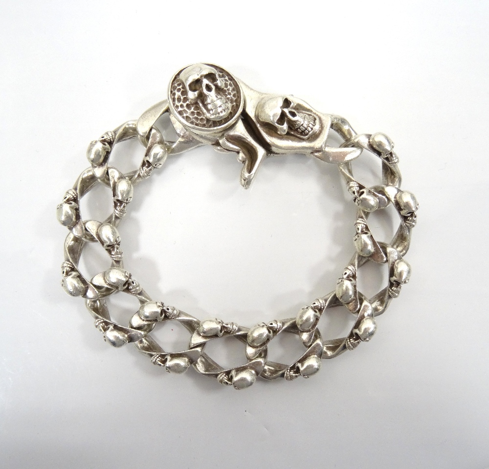 HEAVY GOTHIC STYLE SILVER BRACELET decorated with skulls overall, 22cm long and approximately 93.