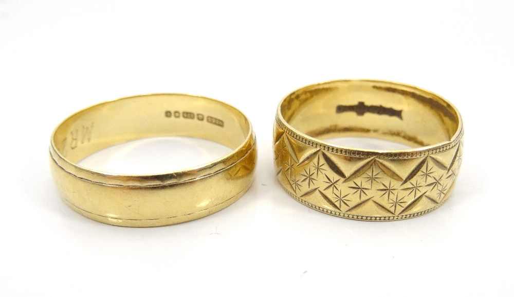 TWO NINE CARAT GOLD WEDDING BANDS one with engraved decoration, ring size P, approximately 3.
