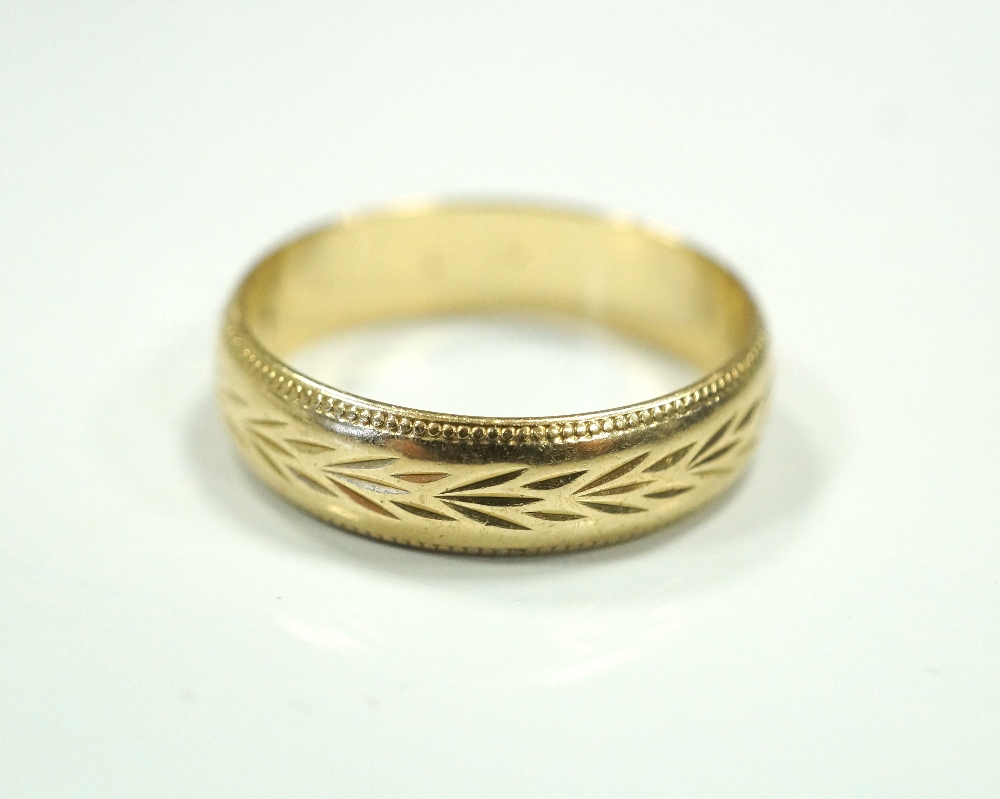 NINE CARAT GOLD WEDDING BAND with engraved decoration, ring size S-T, approximately 3.