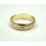 NINE CARAT GOLD WEDDING BAND with engraved decoration, ring size S-T, approximately 3.