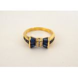 ATTRACTIVE SAPPHIRE AND DIAMOND BOW SHAPED DRESS RING on eighteen carat gold shank,