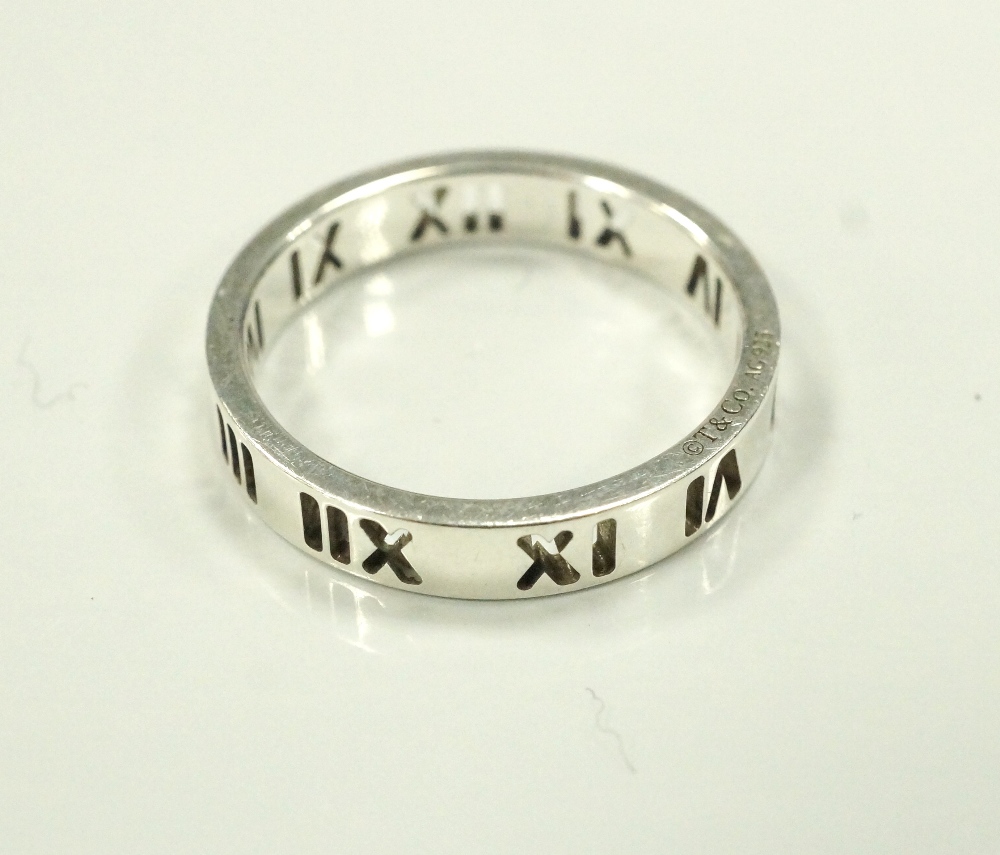 TIFFANY & CO SILVER ATLAS RING with pierced Roman numeral decoration,