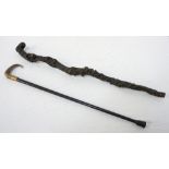 HORN HANDLED WALKING STICK with a gilt metal collar on an ebonised cane, 80cm long,