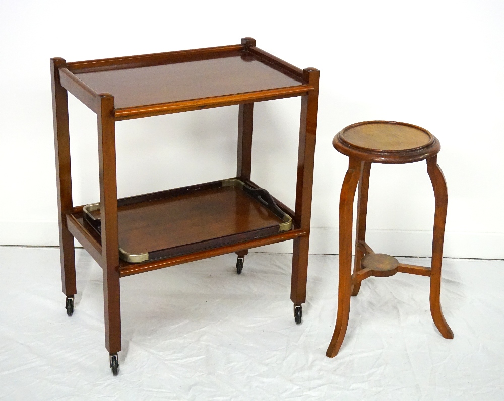 MAHOGANY TWO TIER TROLLEY with moulded edge to both tiers, standing on four supports with castors,