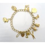 NINE CARAT GOLD CHARM BRACELET with nine carat gold heart clasp, the charms including scissors,