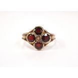 GARNET AND SEED PEARL CLUSTER RING on nine carat gold shank,