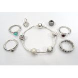 SELECTION OF PANDORA JEWELLERY comprising a silver bracelet with four ball charms, four rings,