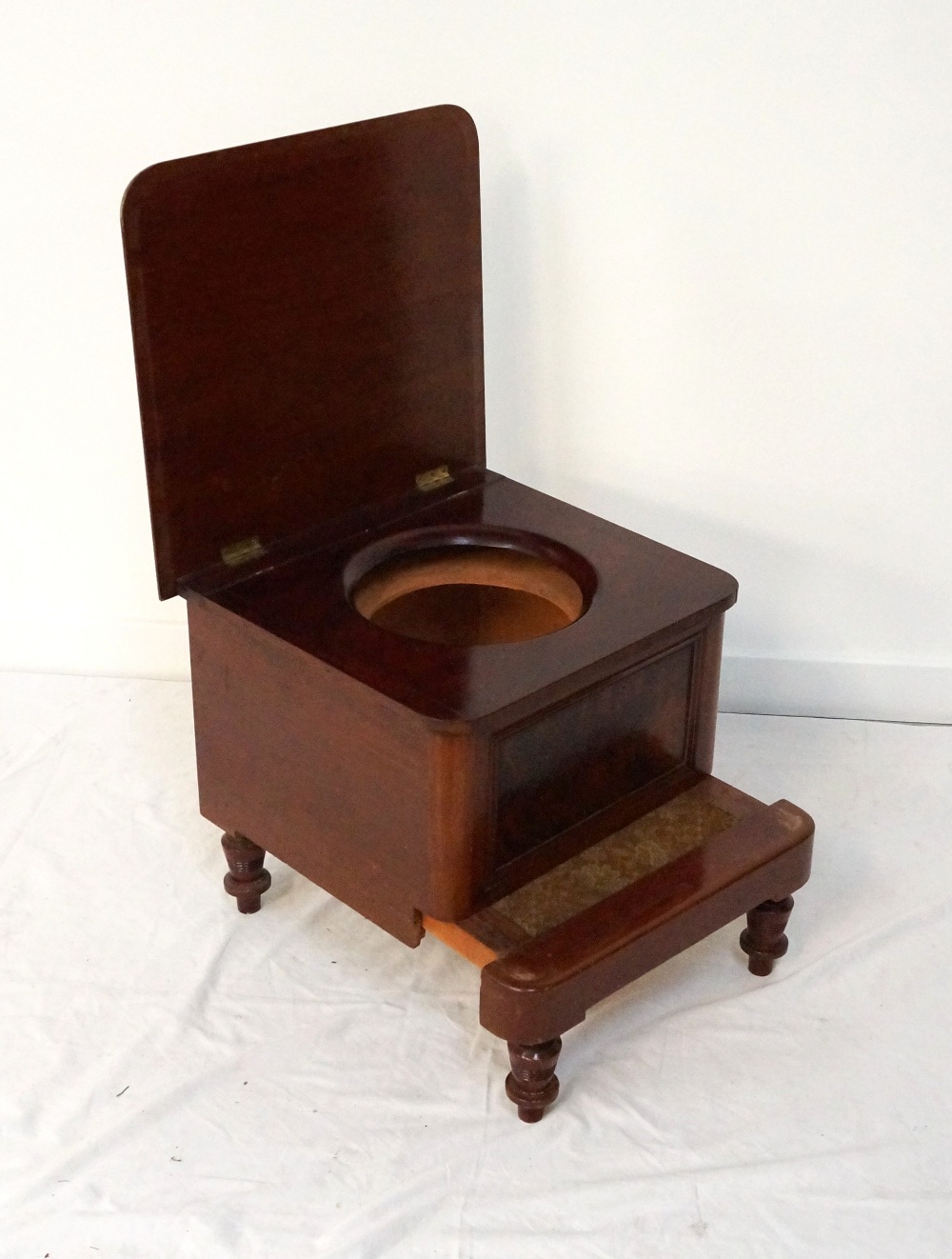 LATE VICTORIAN MAHOGANY STEP COMMODE with a lift up lid and circular recess for the pot,