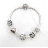 PANDORA MOMENTS SILVER BRACELET with pave barrel clasp and a selection of four charms and one clip