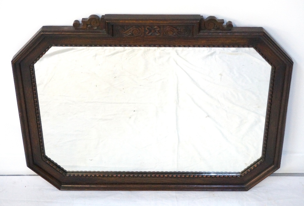 1950's OAK FRAME WALL MIRROR of shaped outline with canted corners,