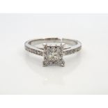 DIAMOND CLUSTER RING the central princess cut diamond in diamond surround and with further diamonds