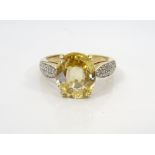 CITRINE AND DIAMOND DRESS RING the central oval cut citrine flanked by diamond set shoulders,