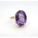 LARGE AMETHYST SINGLE STONE DRESS RING the oval cut amethyst approximately 8.