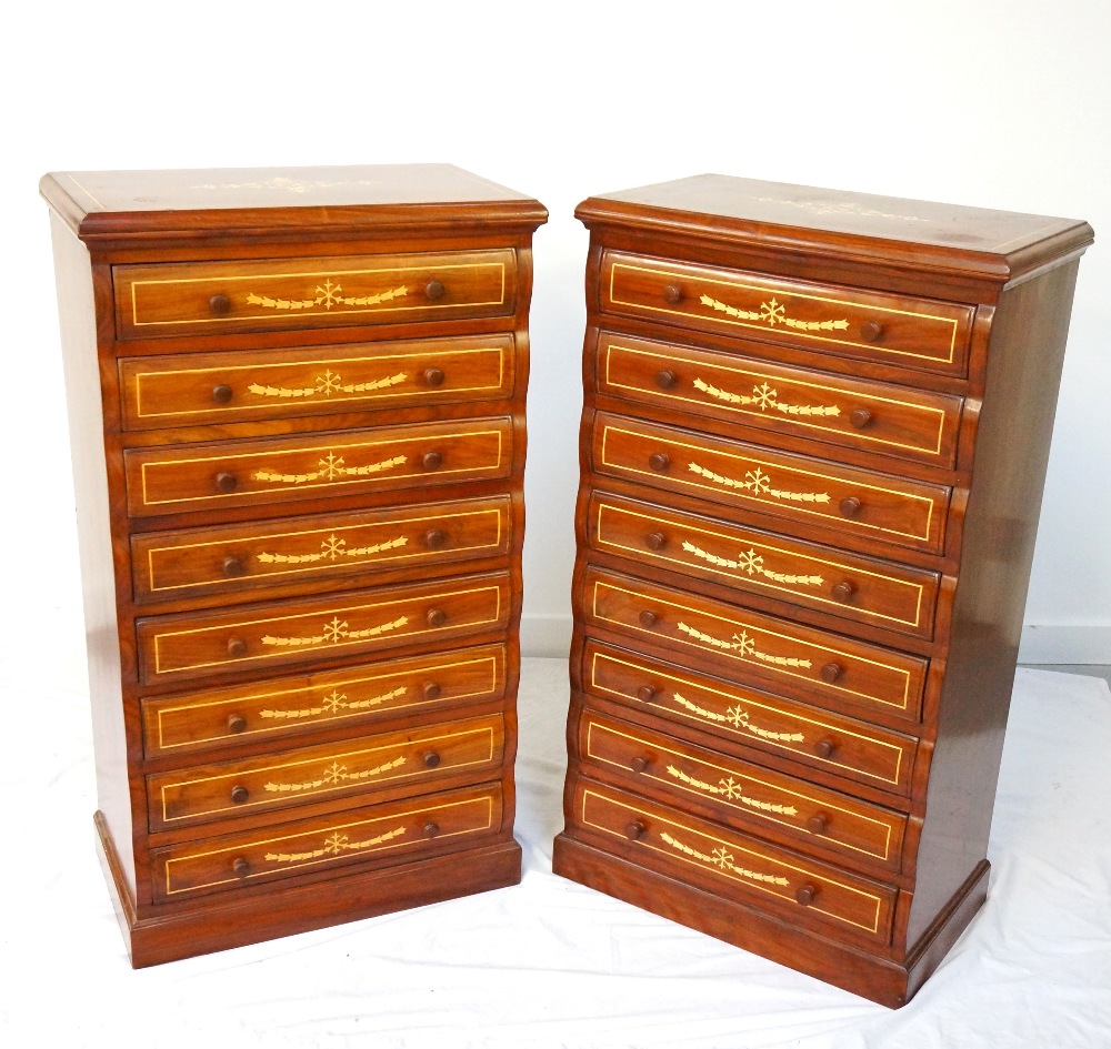 PAIR OF TEAK AND INLAID CHESTS each with a moulded top above eight shaped drawers with turned