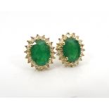 PAIR OF EMERALD AND DIAMOND CLUSTER EARRINGS the central emerald on each approximately 1ct in