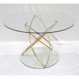 MODERN CIRCULAR GLASS TOPPED TABLE supported on an elliptical brass effect base,