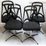 SET OF FOUR MODERN BLACK PLASTIC SWIVEL DINING CHAIRS with pierced backs (From Simon's Flat)