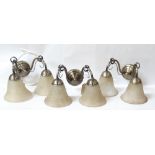 SEVEN ANTIQUE BRASS EFFECT TWIN ARMED WALL LIGHTS with shaped mottled glass shades (two shades