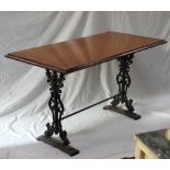 OBLONG TOPPED PUB TABLE with bevelled edge, standing on shaped cast iron supports,