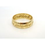 UNMARKED HIGH CARAT GOLD RING the band with engraved Arabic script to the exterior and interior,