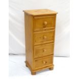 WAXED PINE TALL CHEST with four panelled drawers, standing on bun feet,