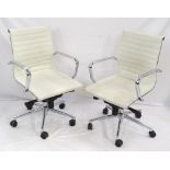 PAIR OF WHITE LEATHERETTE OFFICE ARM CHAIRS with chrome frames and ribbed bodies,