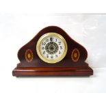 INLAID WALNUT MANTEL CLOCK with shaped case and German movement, raised on small brass feet,