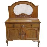 ARTS AND CRAFTS OAK SIDEBOARD with a shaped bevelled mirror back above a base with a moulded edge