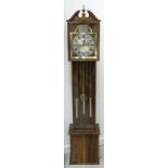 SIMULATED OAK QUARTZ LONGCASE CLOCK with a broken swan neck pediment and urn finial above an arched