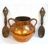 LARGE HAMMERED COPPER TWIN HANDLED POT 31cm high; and a pair of African carved wooden spoons, 44.