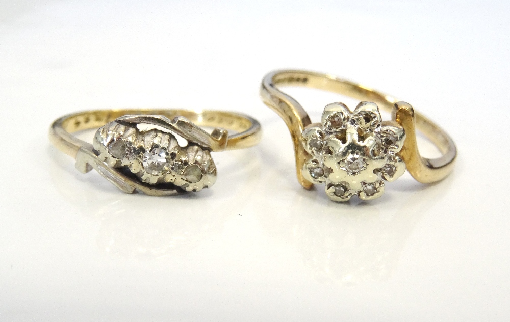 TWO DIAMOND RINGS one a three stone ring, the other a cluster ring,