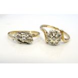 TWO DIAMOND RINGS one a three stone ring, the other a cluster ring,