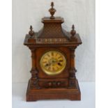 GERMAN WALNUT BRACKET CLOCK the circular dial with Roman numerals, contained in a shaped case,