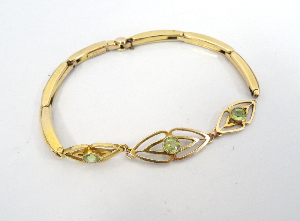 PERIDOT SET NINE CARAT GOLD BRACELET the stone set section on expanding bracelet strap,