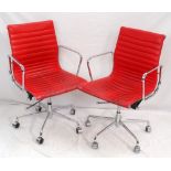 PAIR OF RED LEATHERETTE OFFICE ARM CHAIRS with chrome frames and ribbed bodies,
