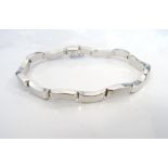 NINE CARAT WHITE GOLD BRACELET with curved links, approximately 8.