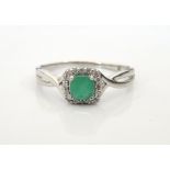 EMERALD AND DIAMOND RING on nine carat white gold shank,