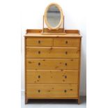 WAXED PINE CHEST with a three quarter galleried top above two short and four long graduated drawers,