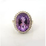 LARGE AMETHYST AND DIAMOND CLUSTER RING the central amethyst in thirty-two diamond surround,