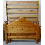 WAXED PINE DOUBLE BED with a shaped head and footboard and slatted base