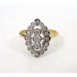 ATTRACTIVE DIAMOND CLUSTER RING the three central diamonds in further sixteen diamond surround,